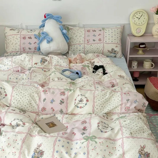 Bed with floral bedding, plush toys, and a clock on a shelf in a bedroom setting.