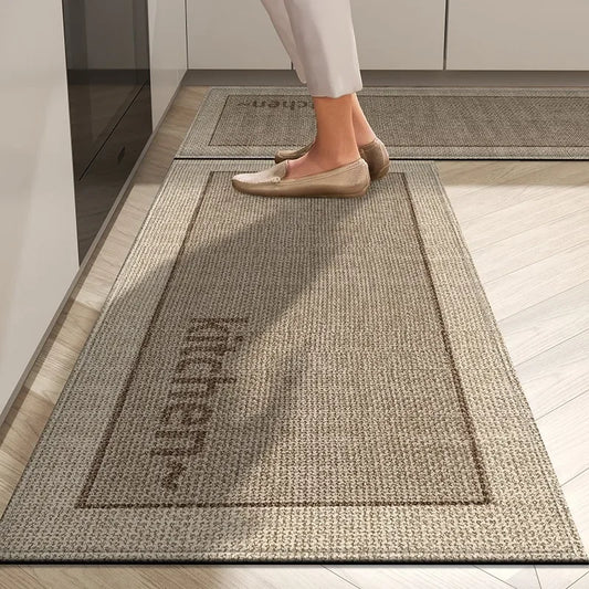 Person stepping onto a textured kitchen mat with 'Kitchen' text on a wooden floor.