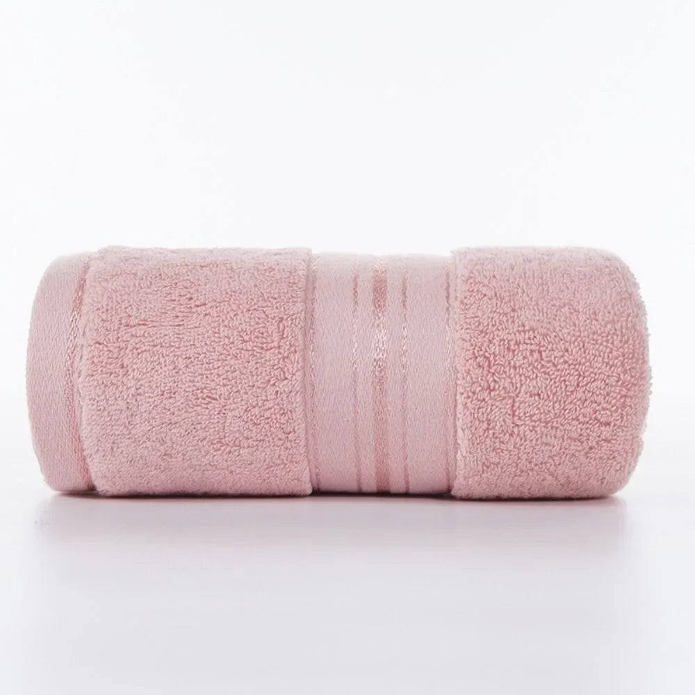 Pink towel rolled up on a white background