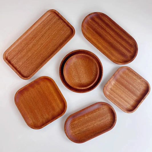 Set of wooden trays and bowls on a white background