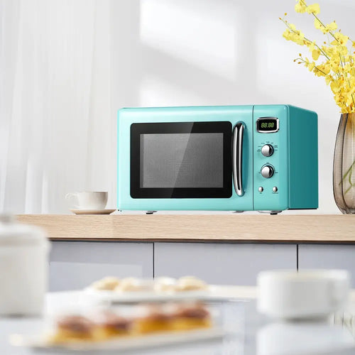Green retro-style Costway 0.9 cu.ft compact countertop microwave oven with digital controls and modern design.