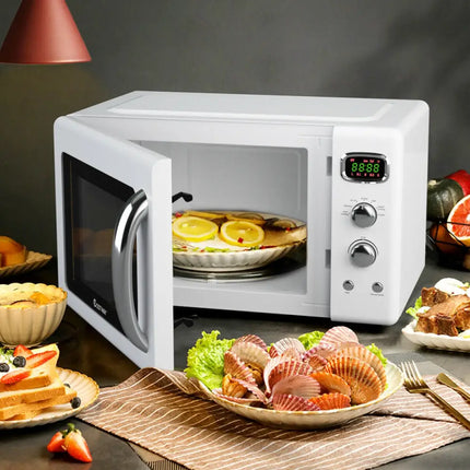 White 0.9 cu.ft Costway retro countertop microwave oven with digital control panel and compact design for small kitchens.