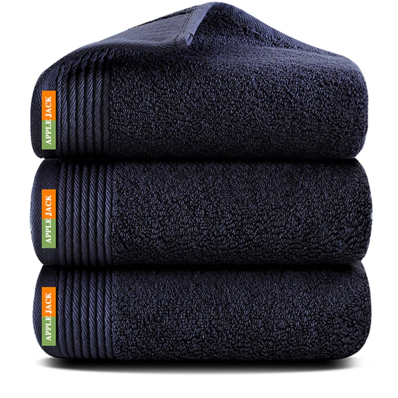 Three folded navy blue towels with Apple Jack labels on a white background