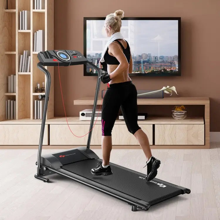 Woman exercising on a treadmill in a home setting with a television displaying a cityscape.