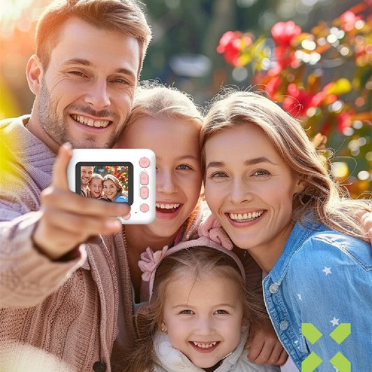 Family taking a selfie with a small camera in a park