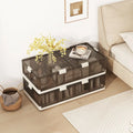 Clear storage box with white accents on a wooden floor next to a bed