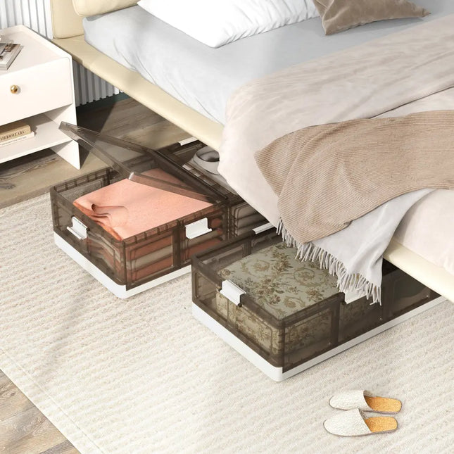 Bed with storage drawers underneath, containing folded clothes on a light-colored carpet.