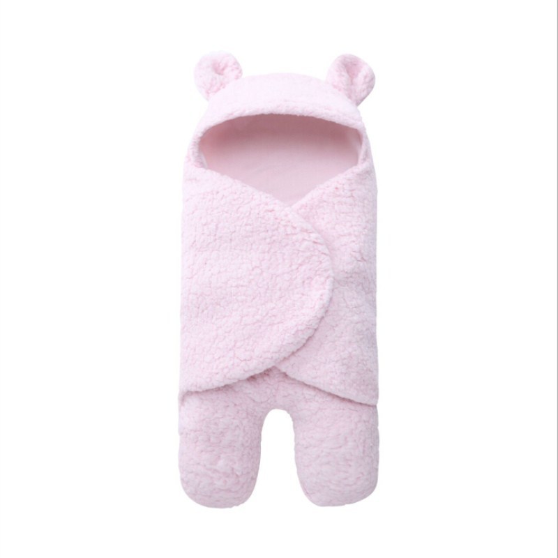 Pink baby sleeping bag with bear ears on a white background
