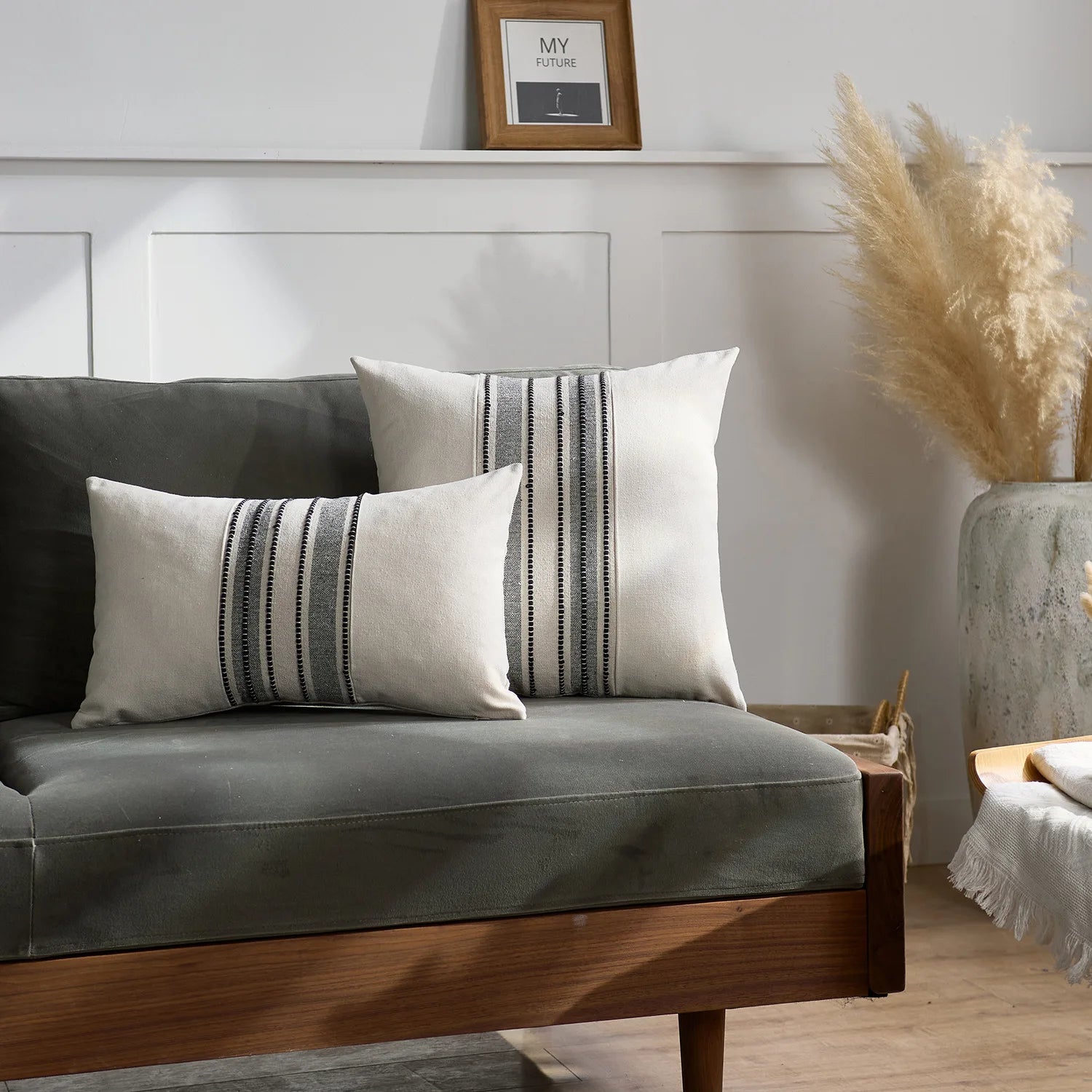 Gray sofa with striped cushions in a room setting
