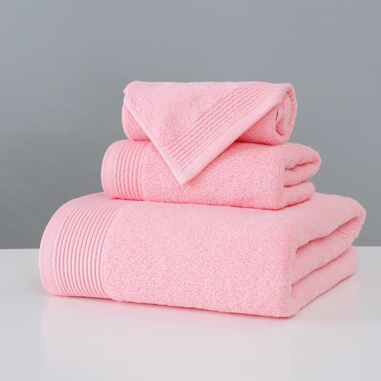 Stack of pink towels on a gray background