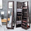 Brown jewelry armoire with mirror in a bedroom setting