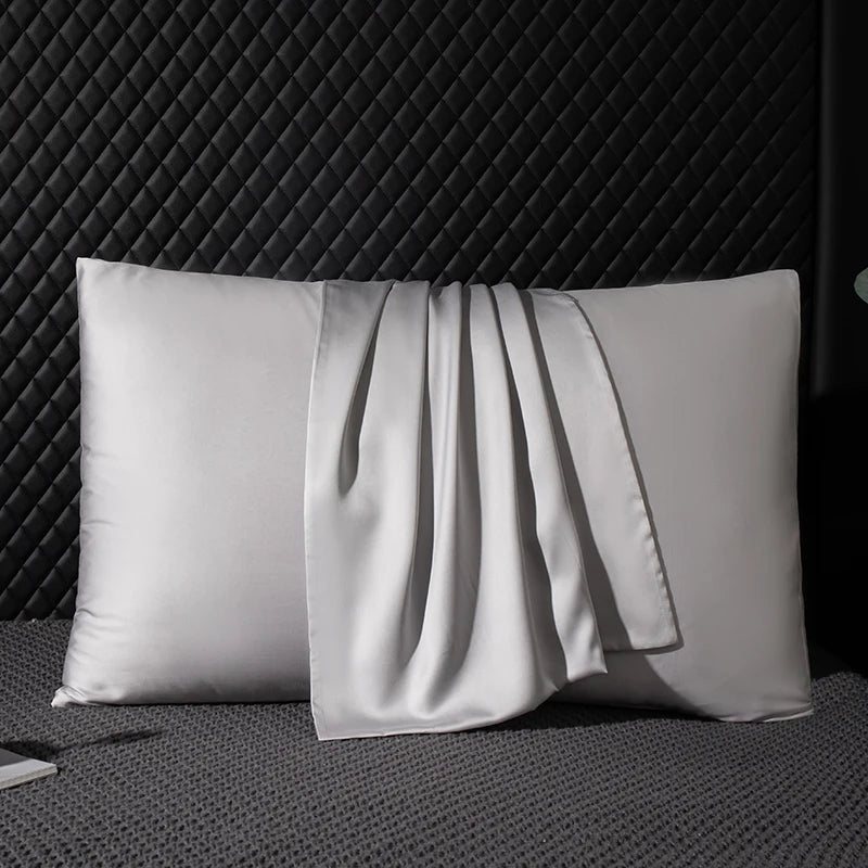 Silk pillowcase on a textured surface with a dark background