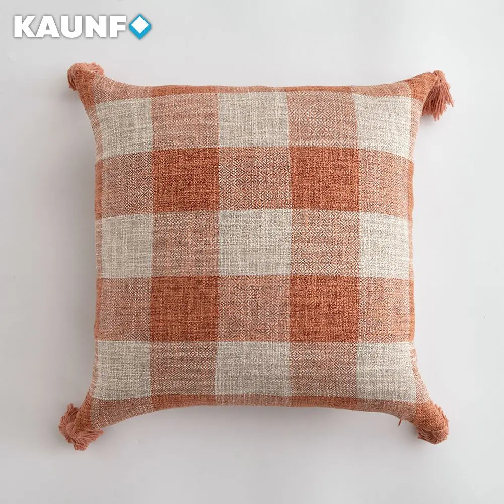 Plaid pillow with tassels on a white background, featuring the KAUNF brand.