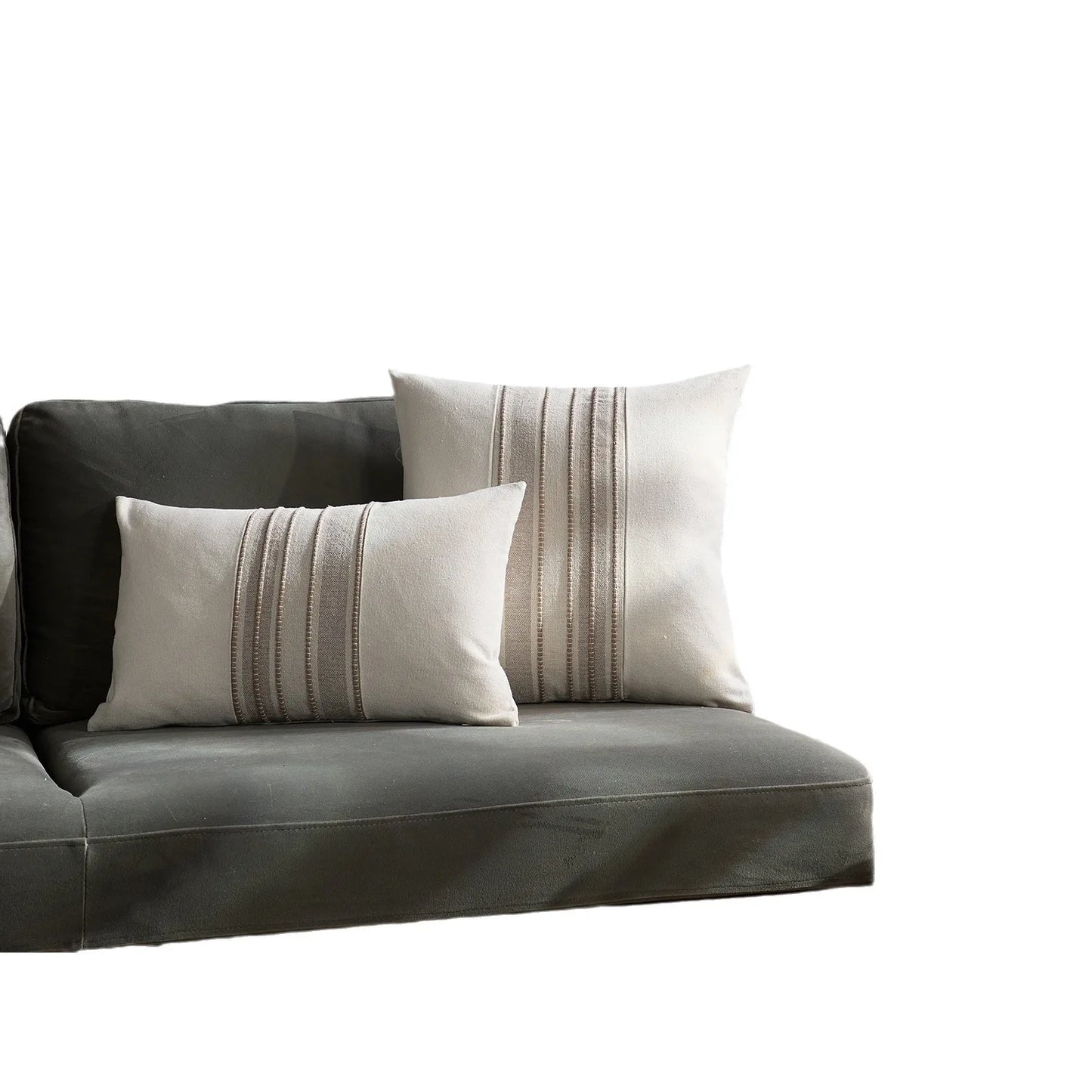Gray sofa with two decorative pillows on a white background