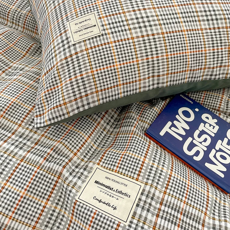 Checkered fabric with labels and a book titled 'Two Sister Notes' on top