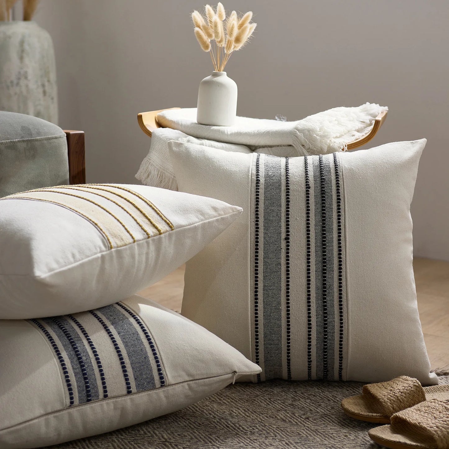 Decorative pillows with striped patterns on a couch in a cozy living room setting.