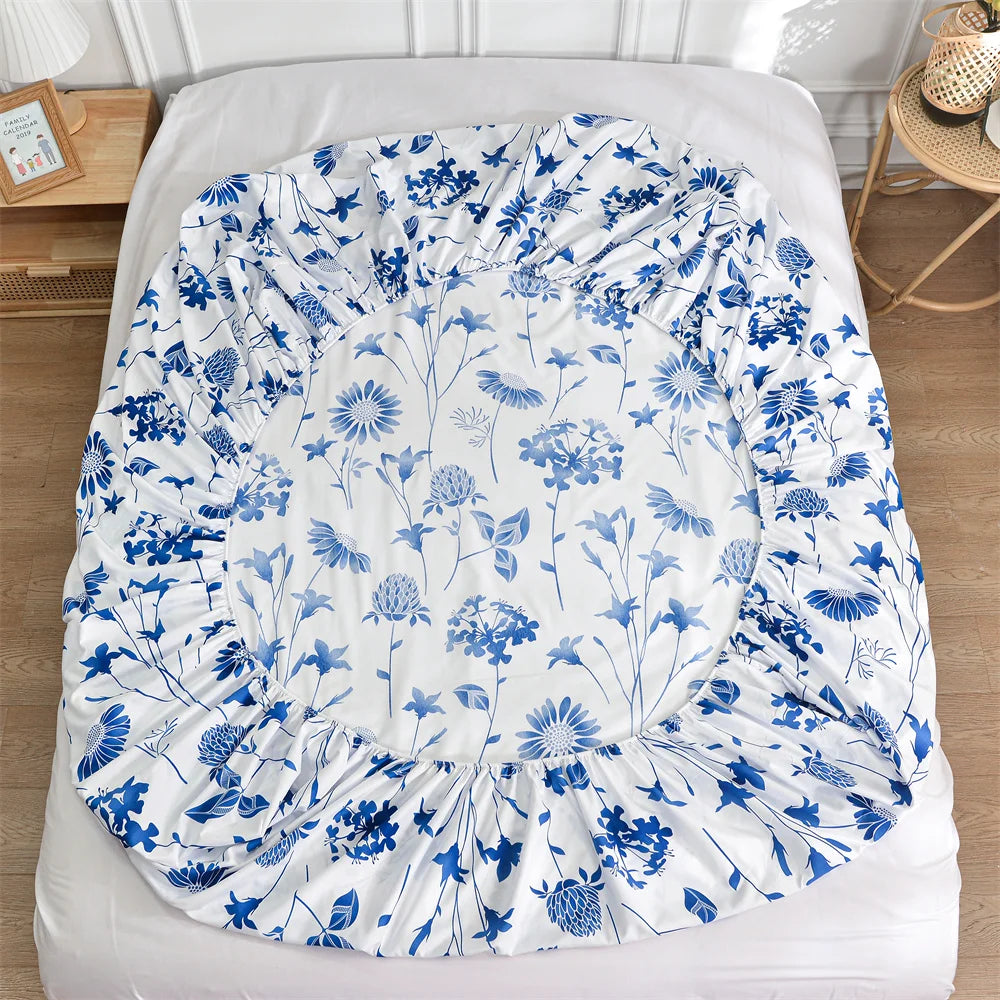 Floral patterned fitted sheet on a bed with a white background