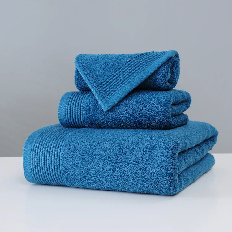 Stack of blue towels on a white surface with a gray background