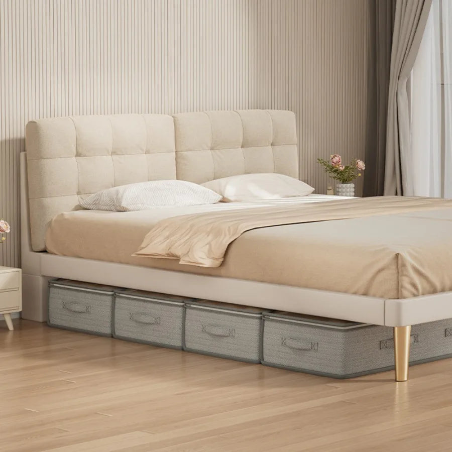 Beige upholstered bed with storage drawers in a bedroom setting