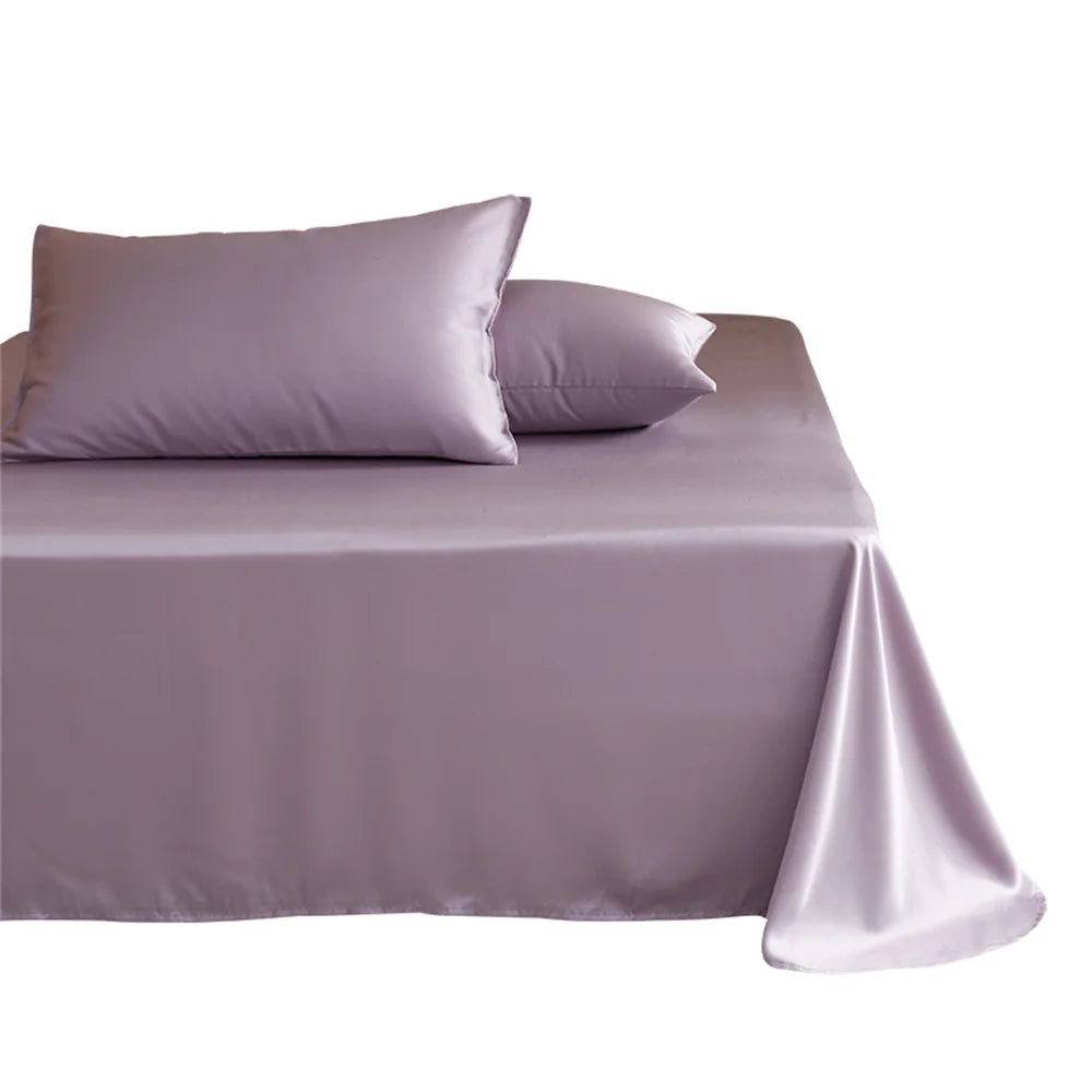 Purple satin bedspread and pillows on a white background