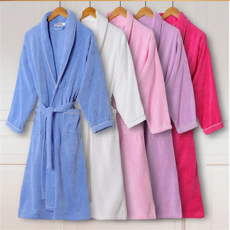 Set of five bathrobes in blue, white, pink, purple, and red hanging on wooden hangers against a light background.