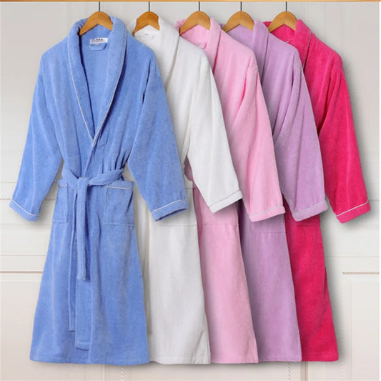Set of five bathrobes in blue, white, pink, purple, and red hanging on wooden hangers against a light background.