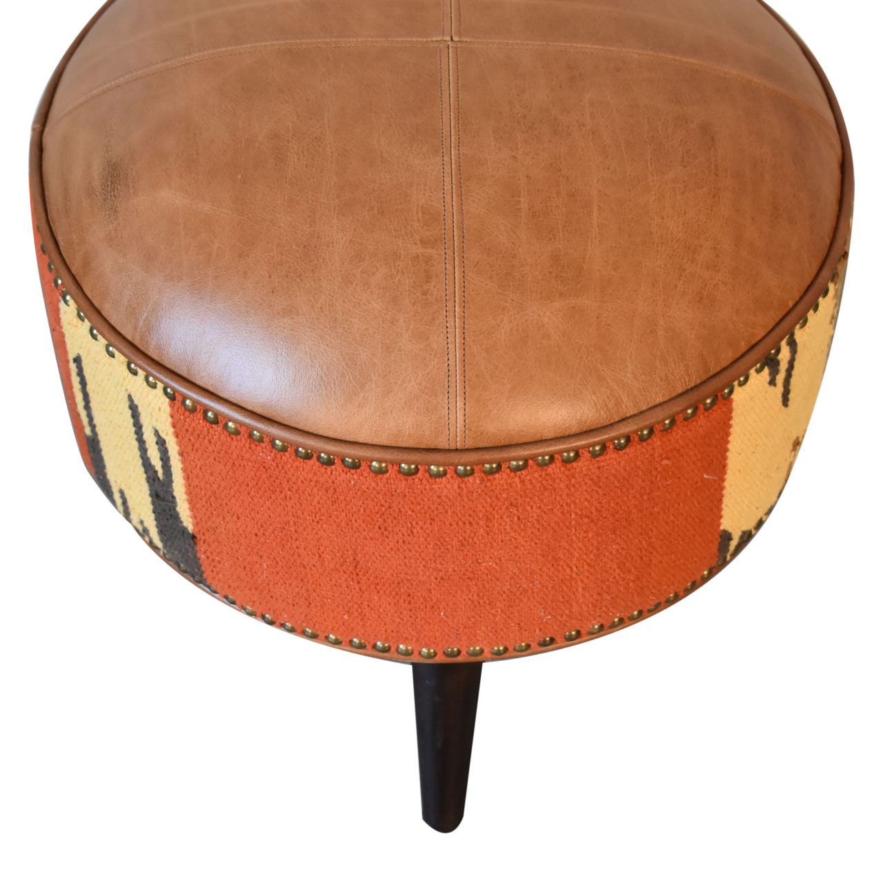 Durrie & Leather Mixed Footstool with Nordic-style legs, buffalo leather, and durrie print. Top view