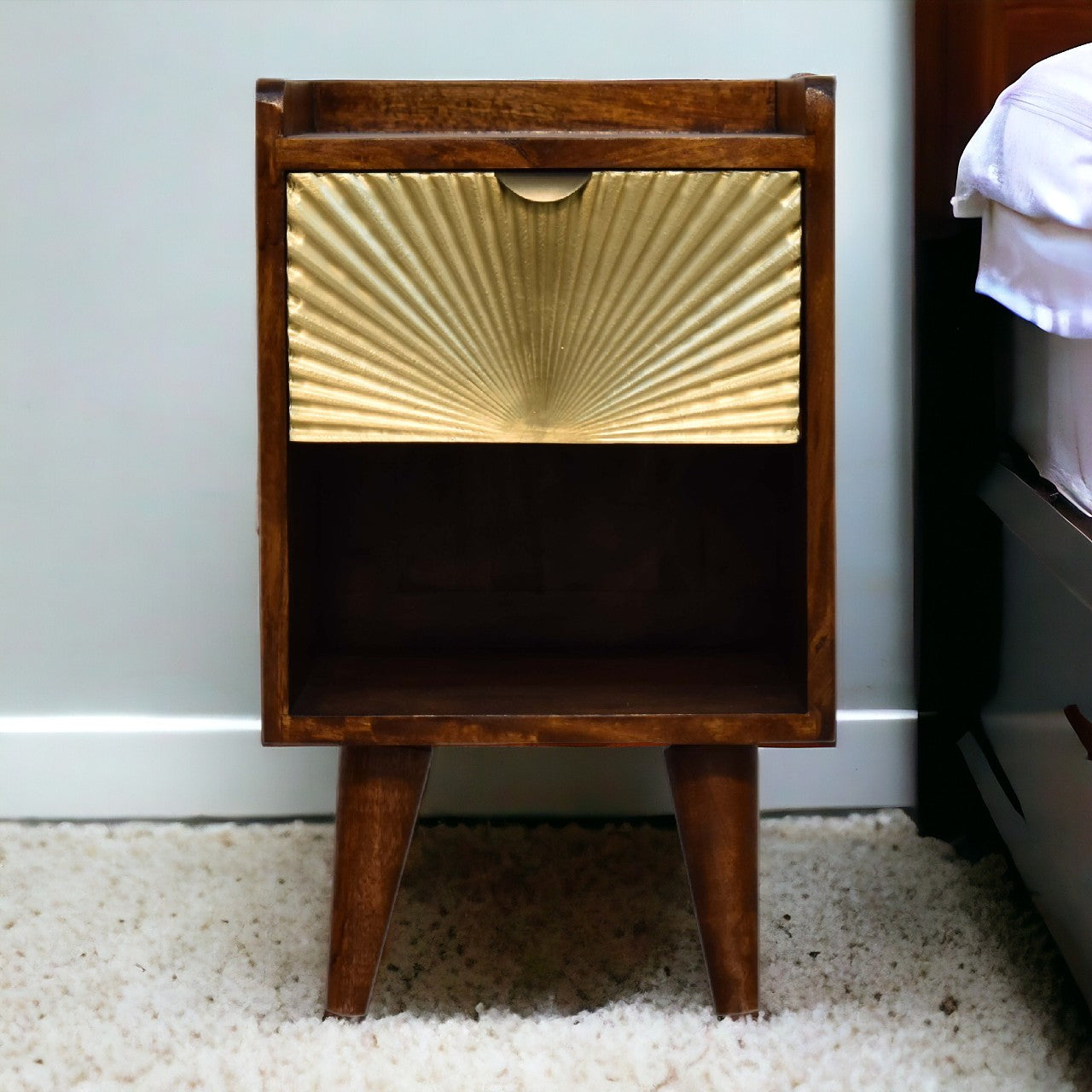 Mini Manila Gold Chestnut Nightstand with brass-plated drawer, open storage slot, and Nordic-style legs. Positioned by a bedside.