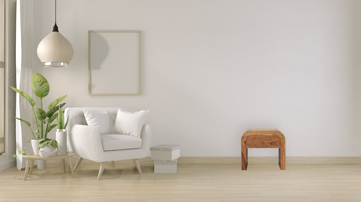 Darcy nightstand with one drawer, open shelf, brass knob, and solid mango wood frame in chestnut finish. Nightstand in a living space.