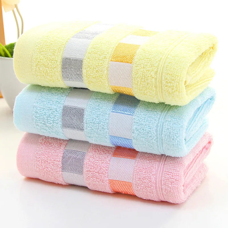 Stack of colorful checkered towels on a white surface