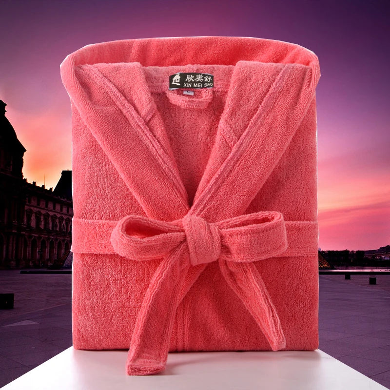 Pink bathrobe with a brand label on a blurred architectural background