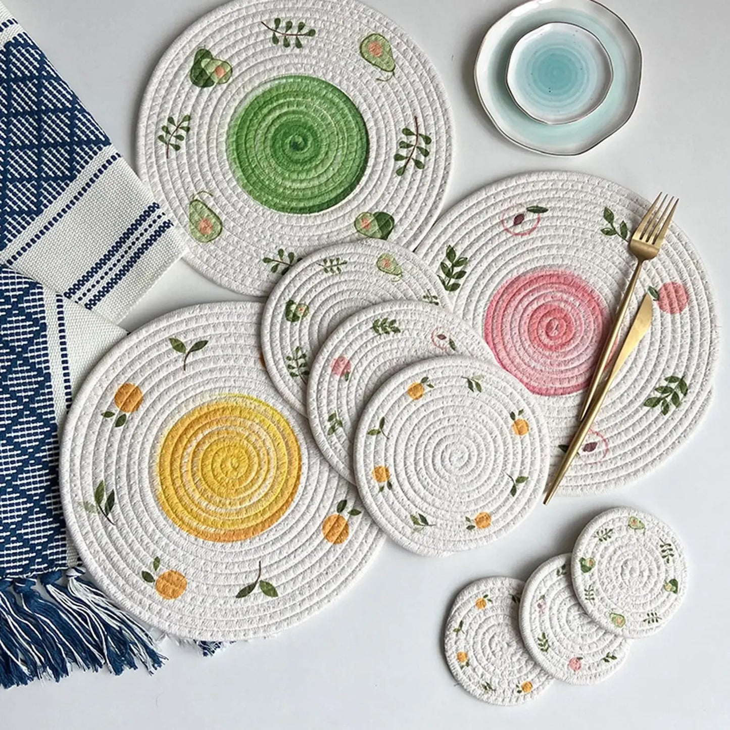 Set of round woven placemats with floral patterns on a light gray background