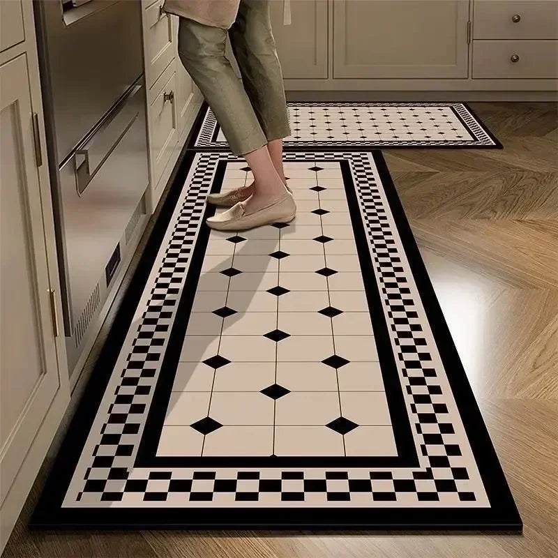 Person stepping onto a black and white patterned rug in a kitchen.