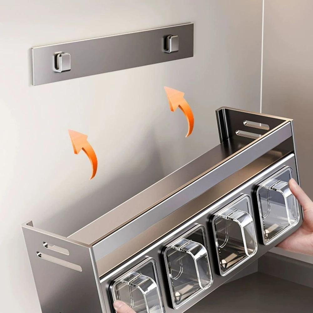 Metal wall-mounted storage shelf with clear compartments on a light gray background