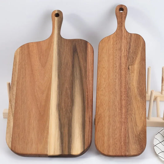 Two wooden cutting boards with handles on a light gray background