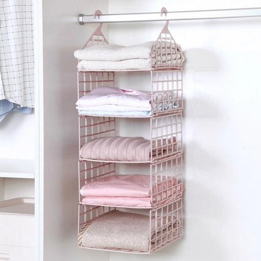 Pink hanging shelf organizer with folded clothes in a closet.