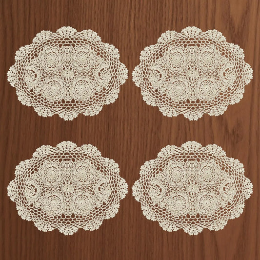 Four lace doilies on a wooden surface
