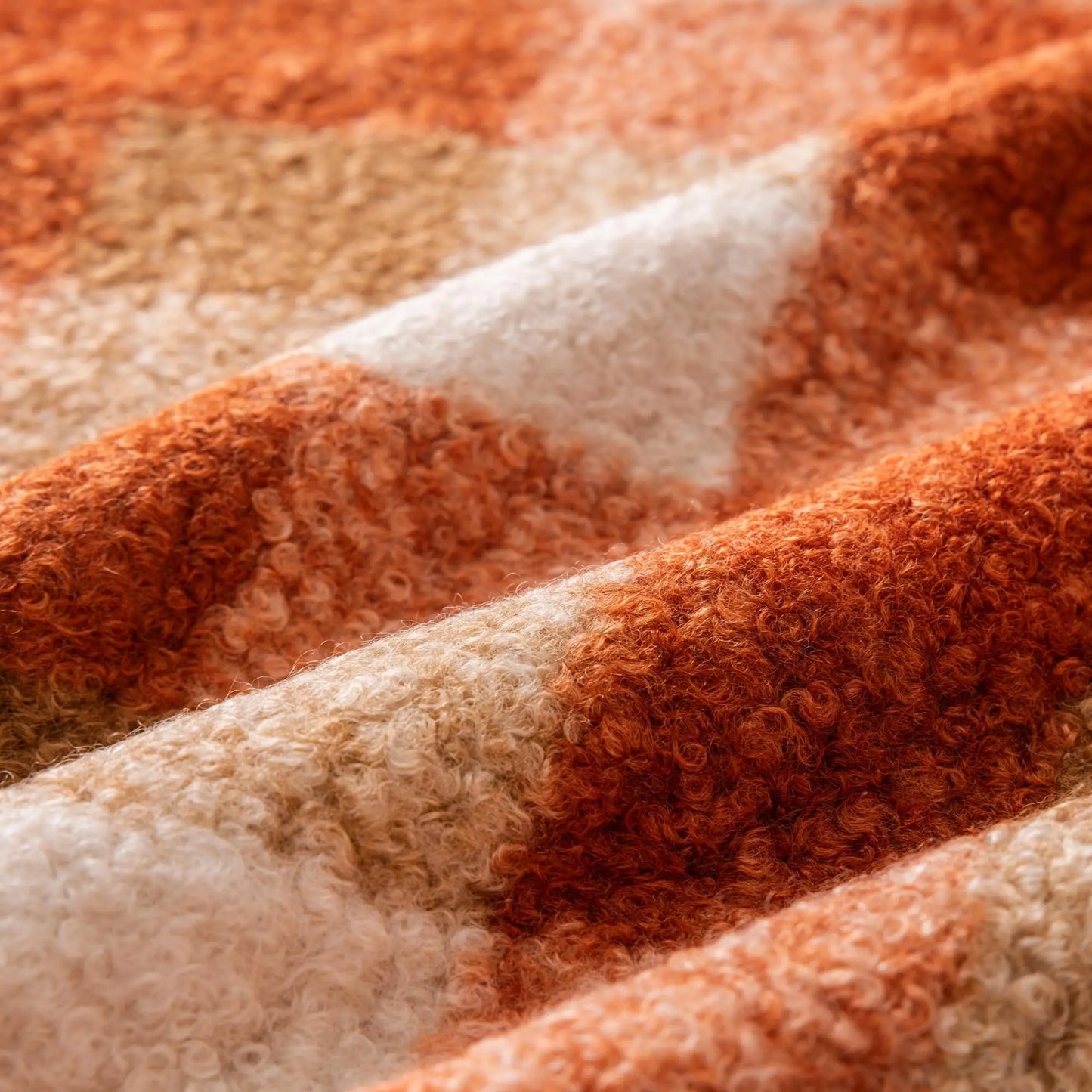 Close-up of a textured fabric with orange and beige stripes