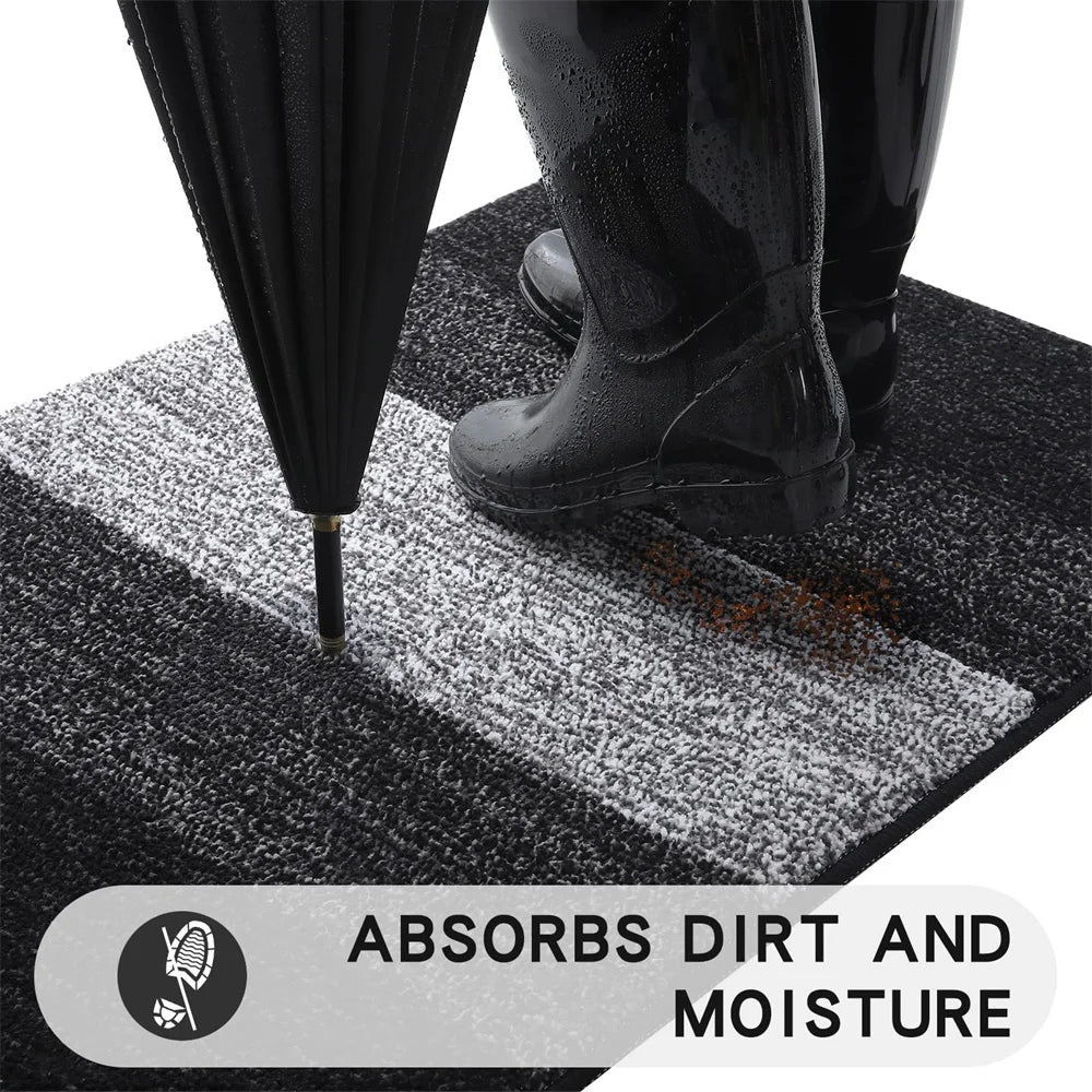 Person using a black umbrella on a textured mat with text 'Absorbs Dirt and Moisture'.