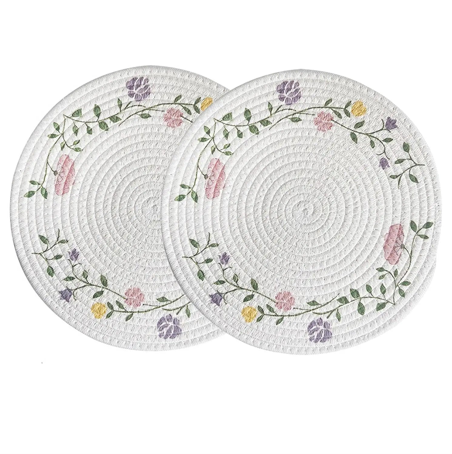 Two round woven placemats with floral patterns on a white background