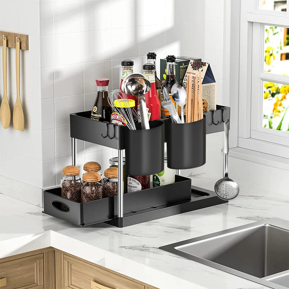 Black kitchen organizer with utensils and bottles on a countertop.