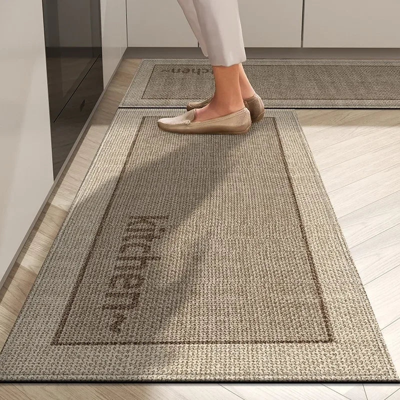 Person stepping onto a textured kitchen mat with 'Kitchen' text on a wooden floor.