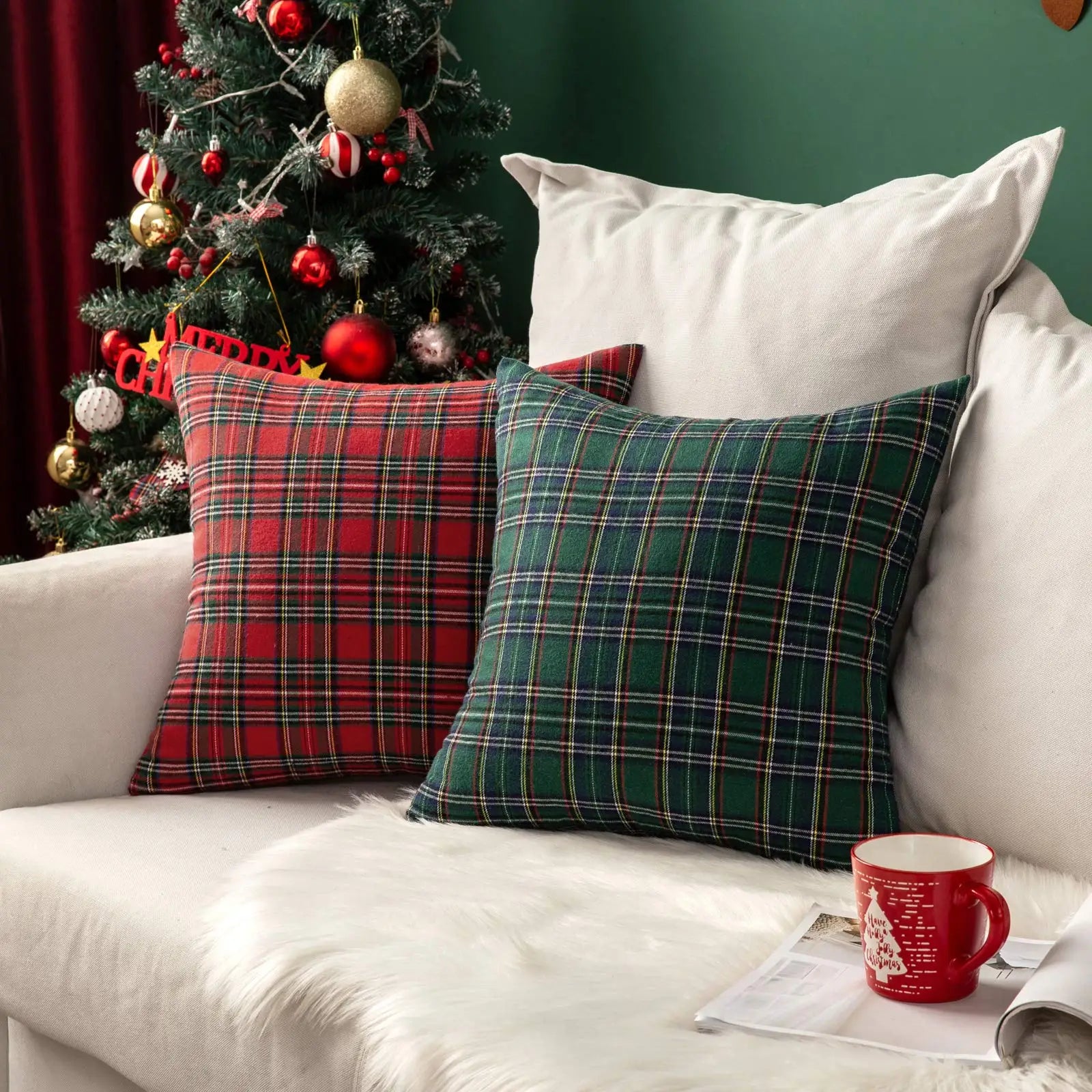 Plaid cushions on a sofa with a Christmas tree in the background