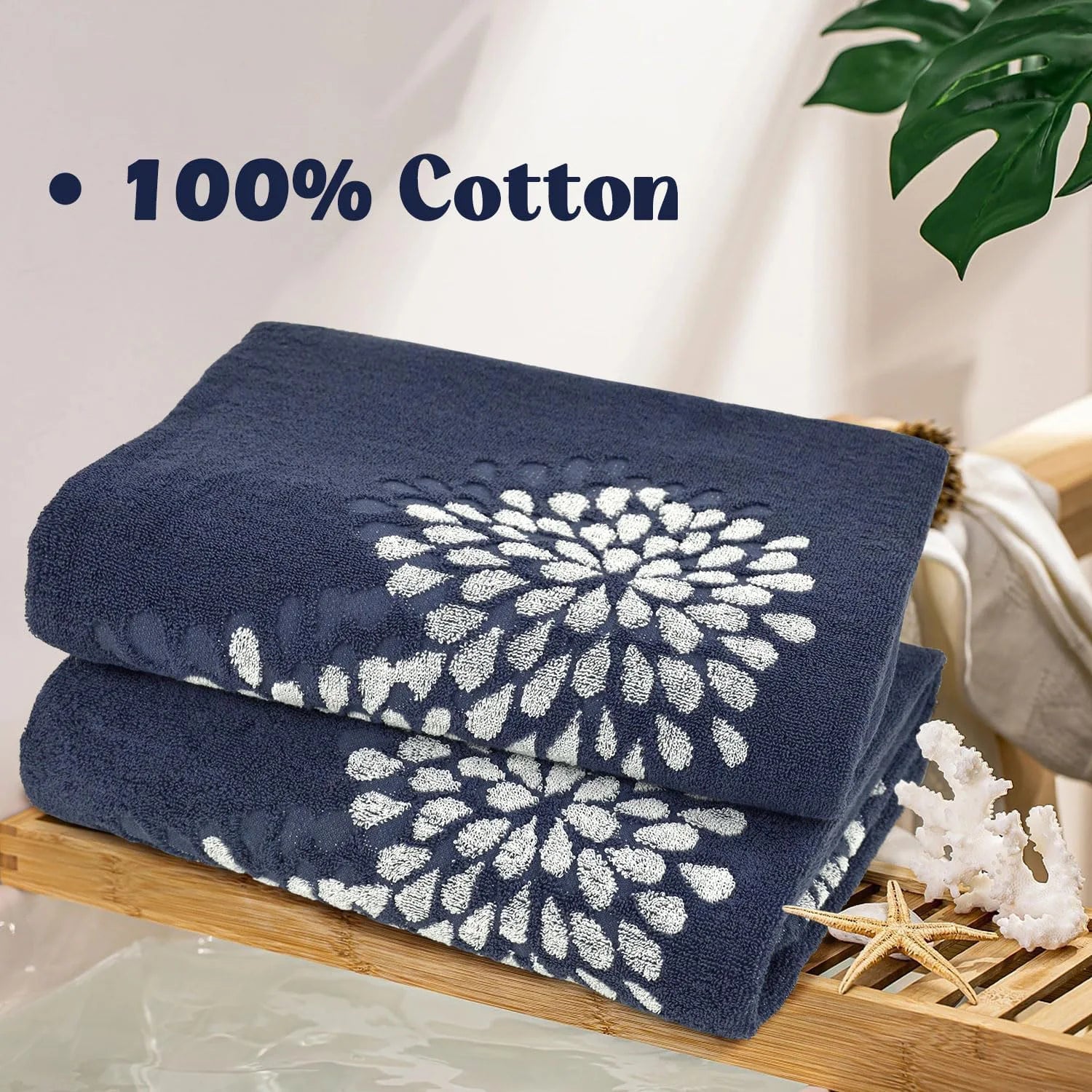 Two navy blue towels with white floral patterns on a wooden shelf.