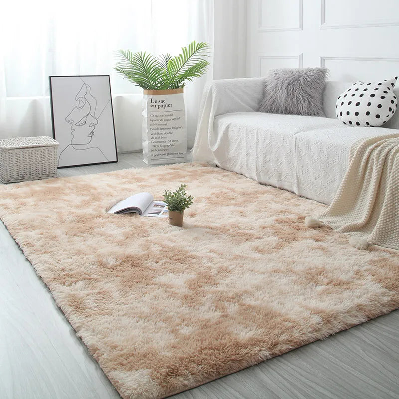 Beige rug in a living room with a sofa, plants, and decor items.