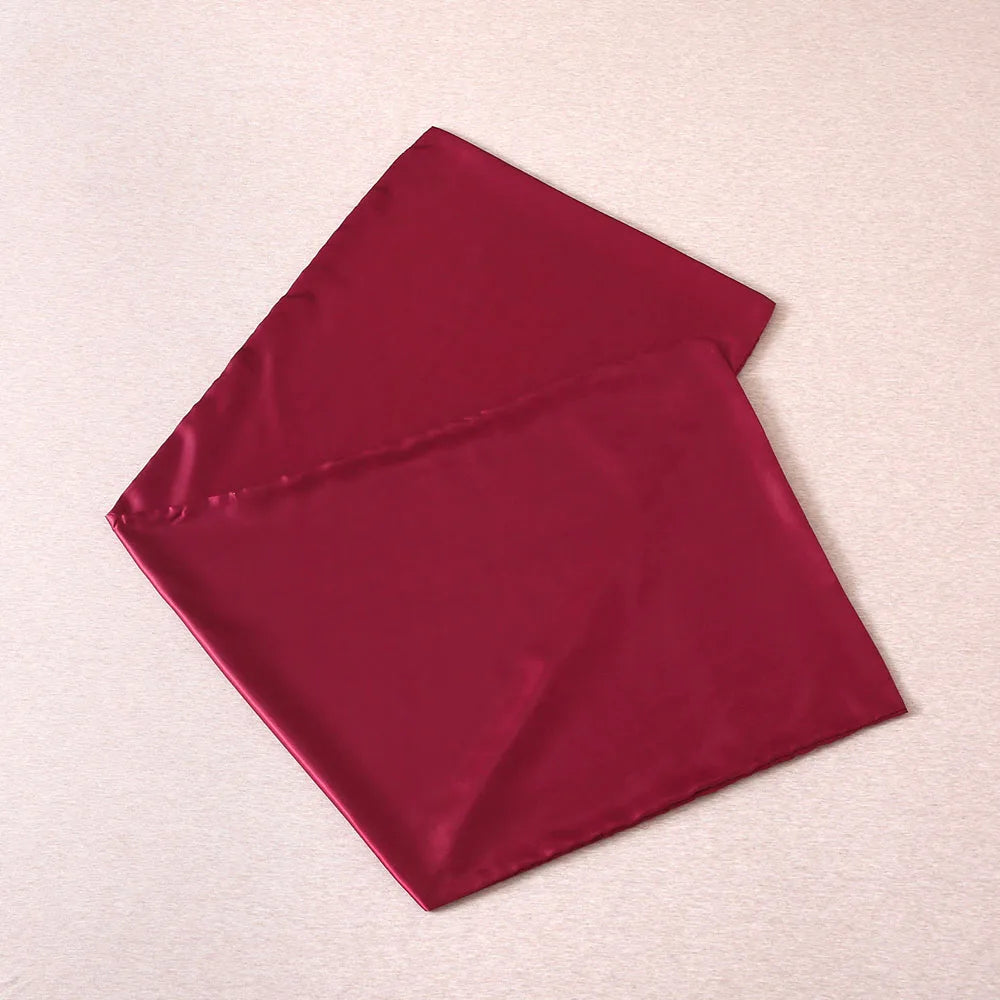 Folded burgundy fabric on a beige background