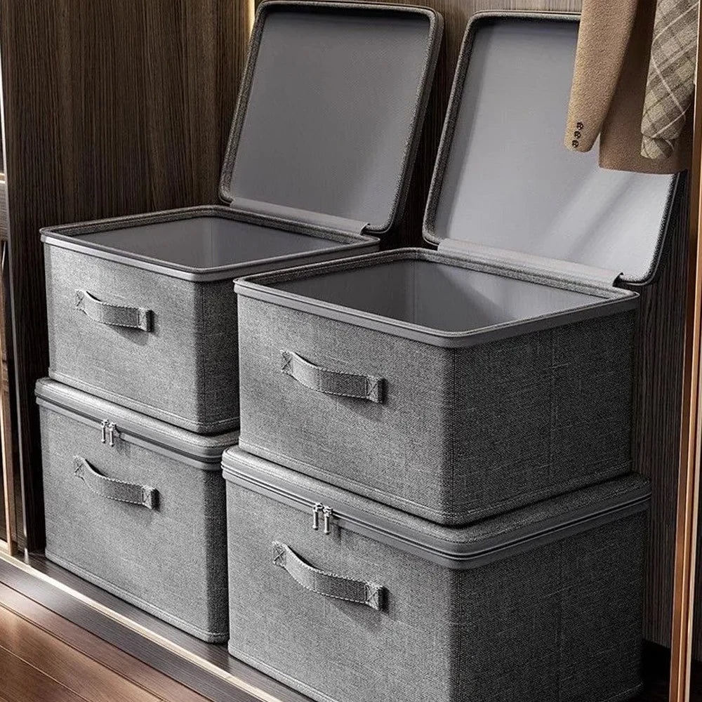 Set of gray storage boxes with lids on a wooden surface.