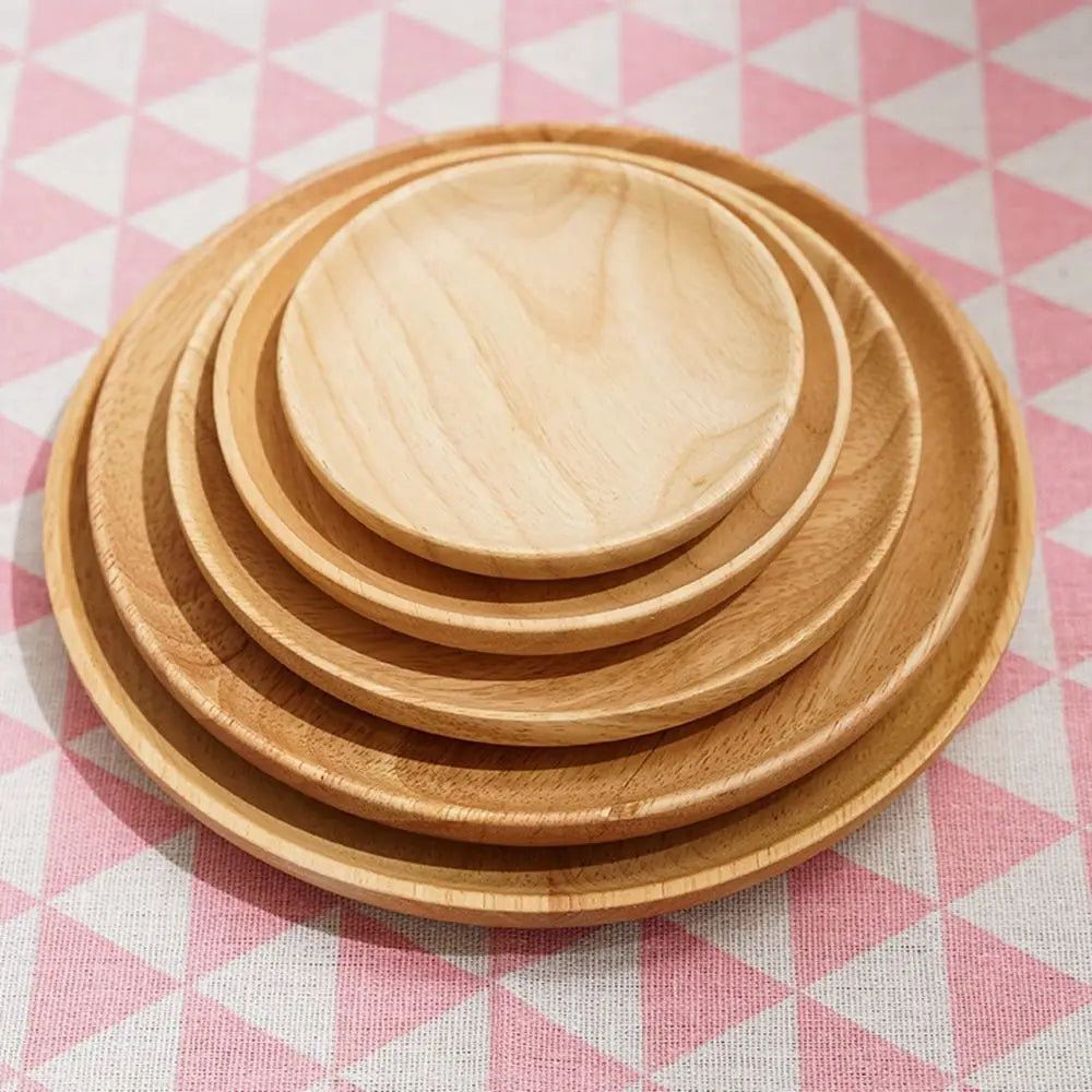 Stack of wooden plates on a pink and white checkered tablecloth