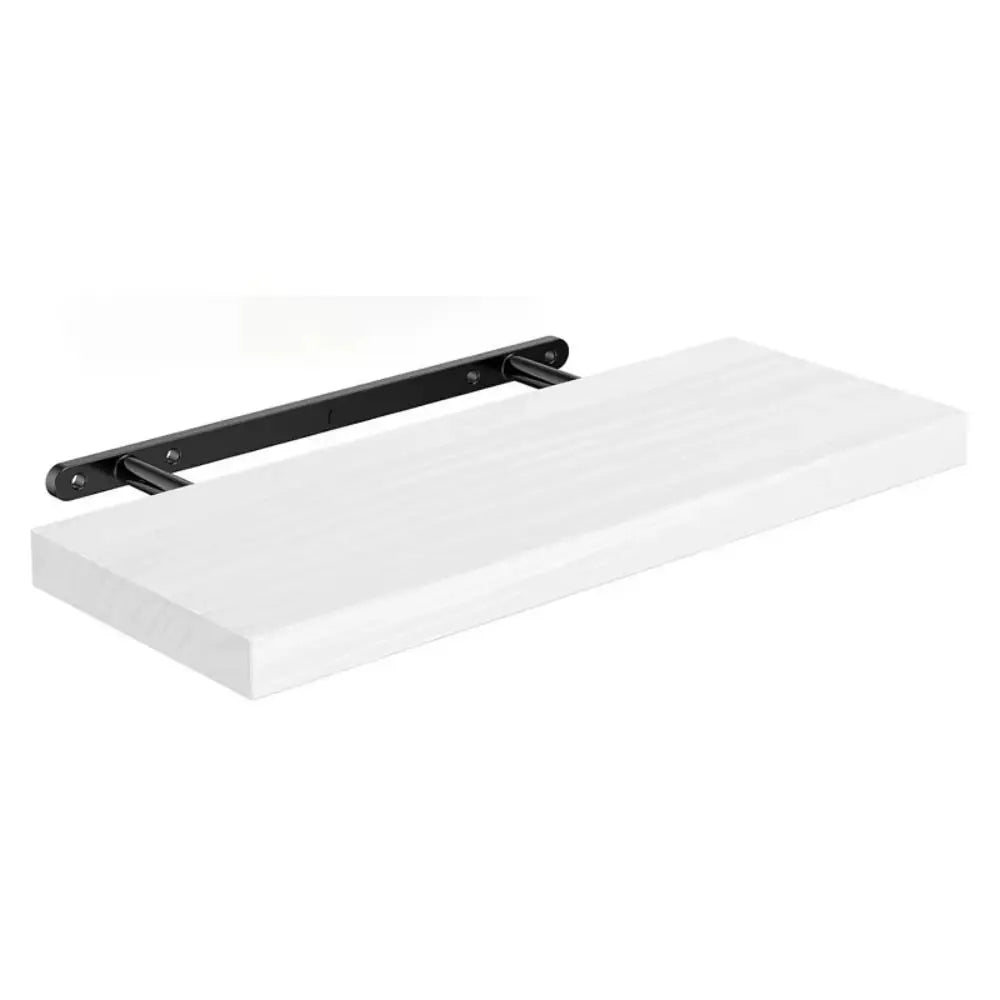 White wall shelf with black brackets on a white background