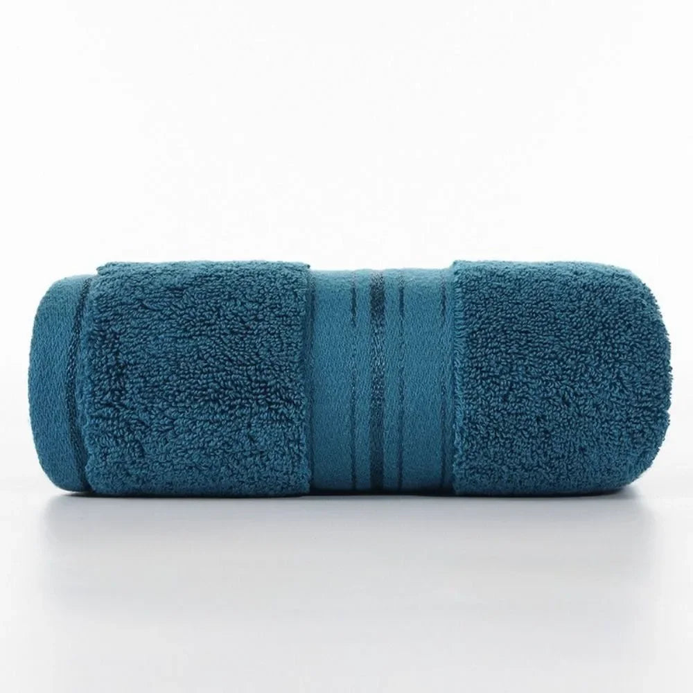 Rolled teal towel on a white background